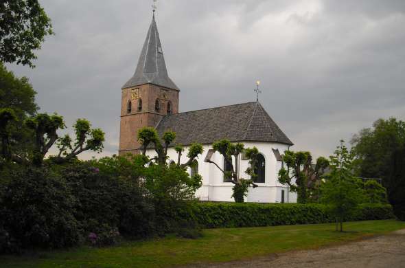 Beeld bij Het eeuwenoude witte kerkje van Heemse